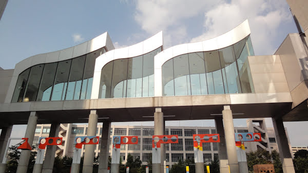 the entranceway features metal and glass accents resembling flags flying in wind
